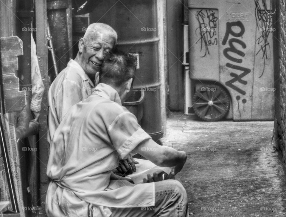 Two Cooks Taking A Break In An Alley. Old Friends Sharing A Joke
