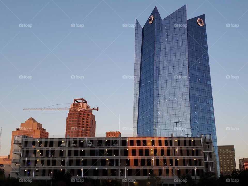 City buildings at sunset ! The blue one is Frost Bank.