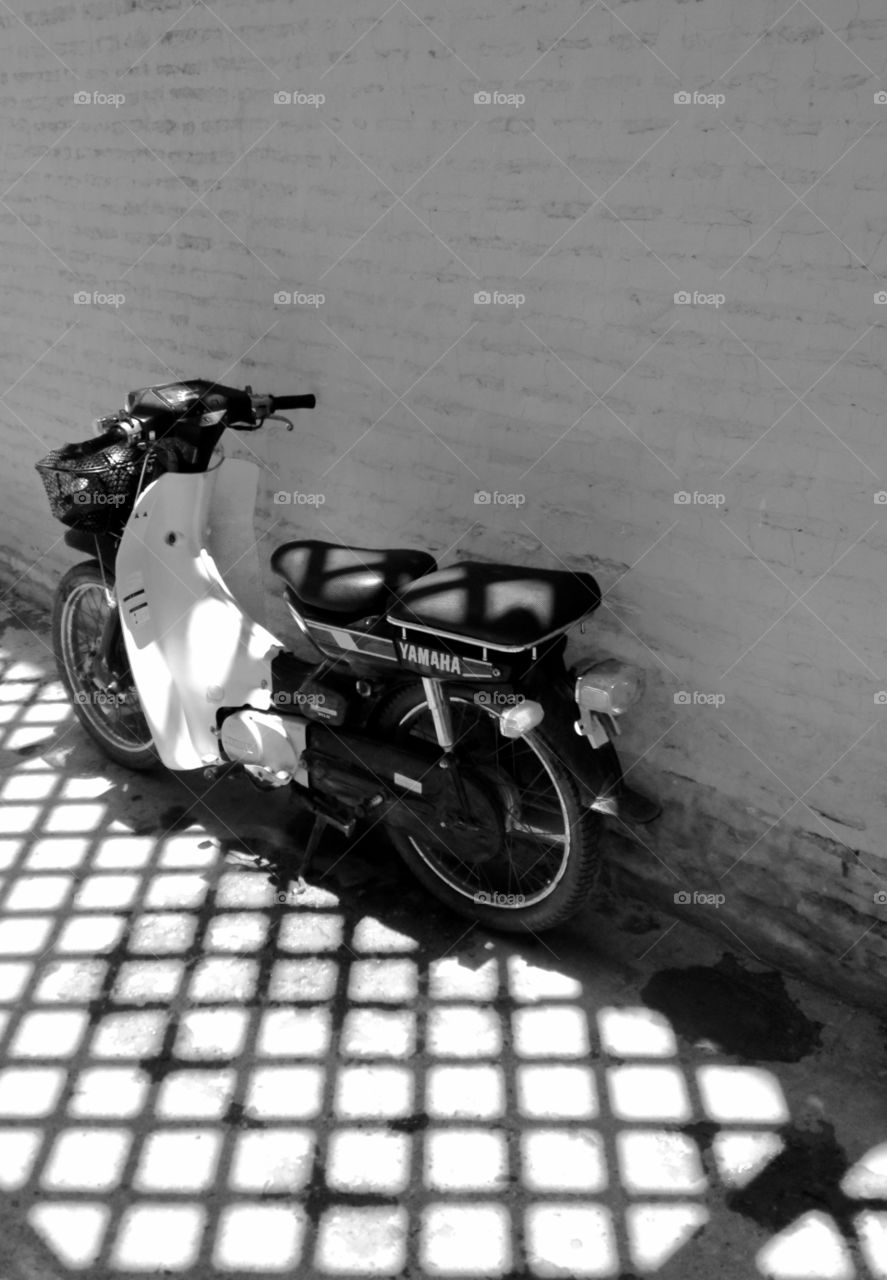 Shadows on a motorbike in Marrakech, Morocco 