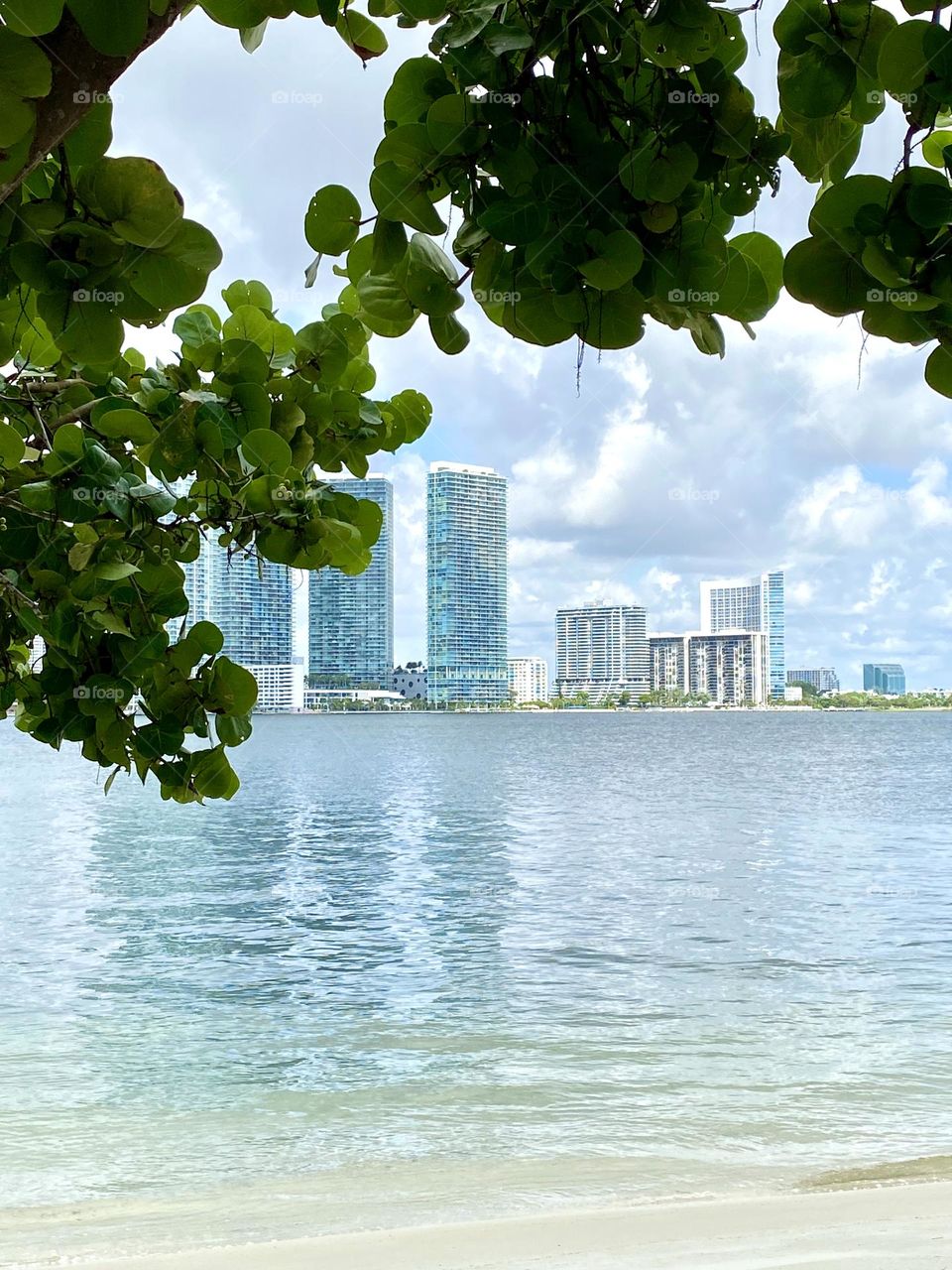 Miami from distance, reflections on water, dramatic 