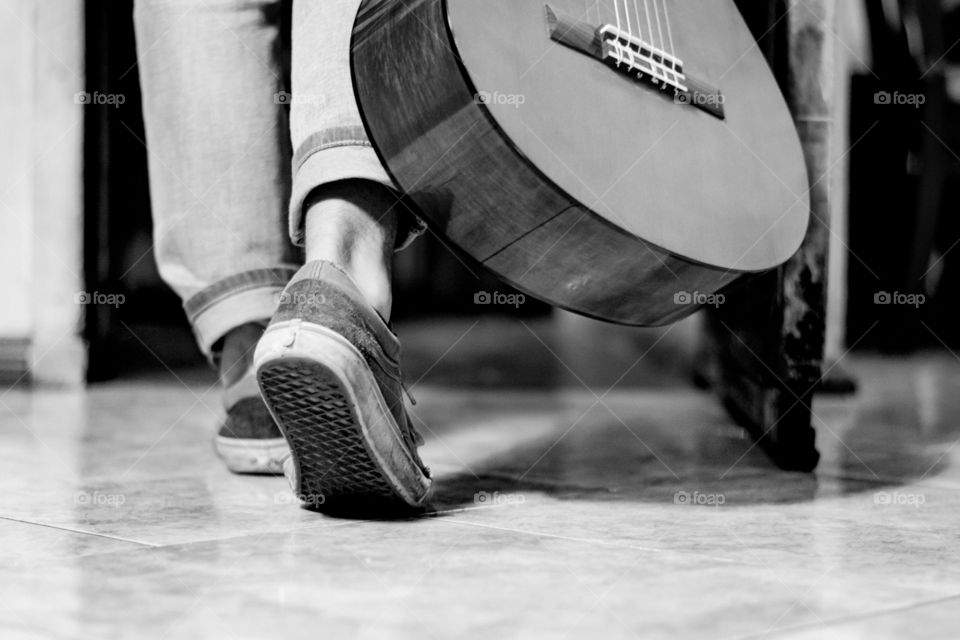 Black and white of a man and his guitar 