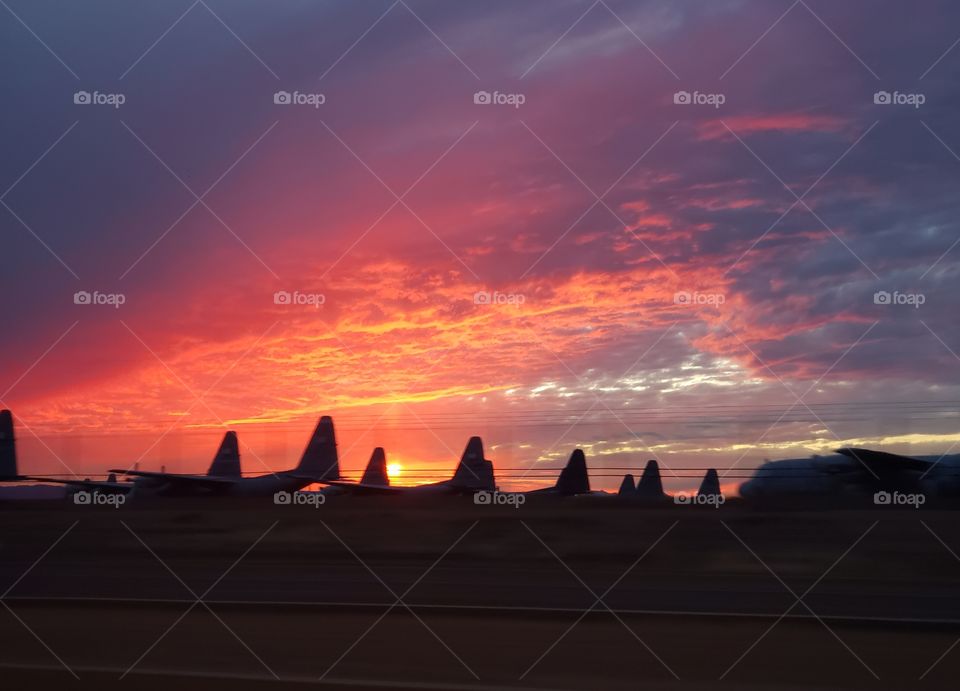 sunset behind the planes in the graveyard.