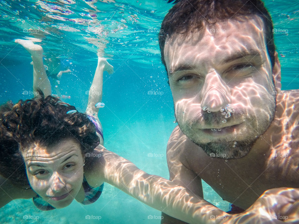 Woman and man swimming in sea