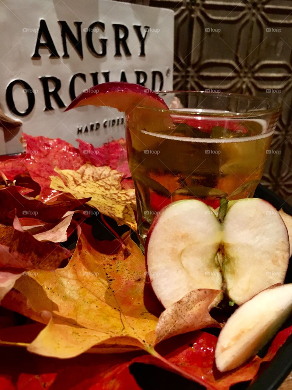 Fall leaves and sliced Apple promoting hard Apple cider