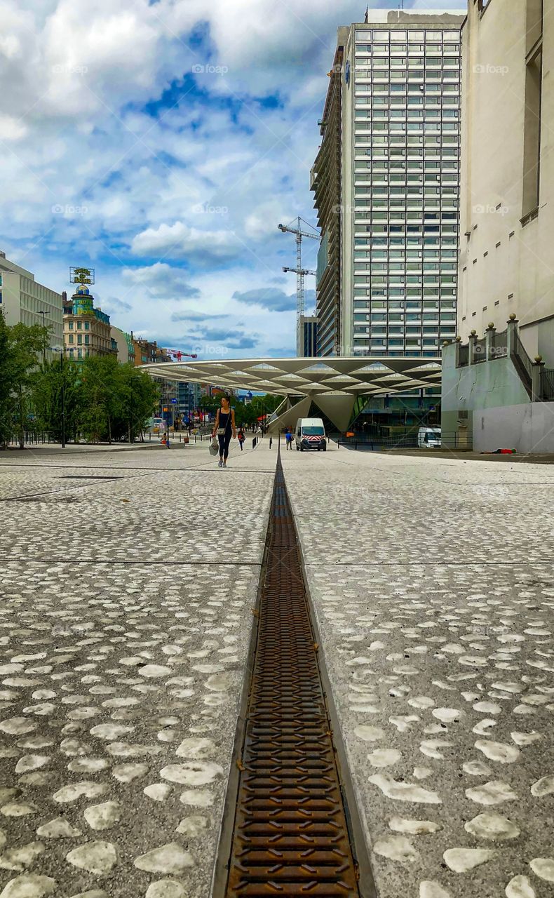 Converging lines on the pavement and the buildings in the city