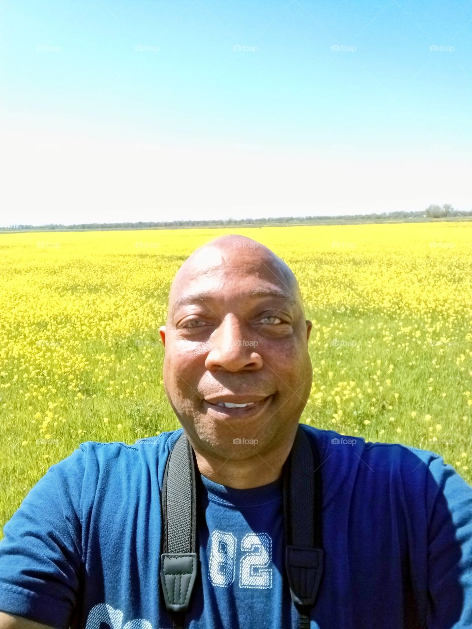 selfie pic in a field of yellow flowers on a beautiful spring day