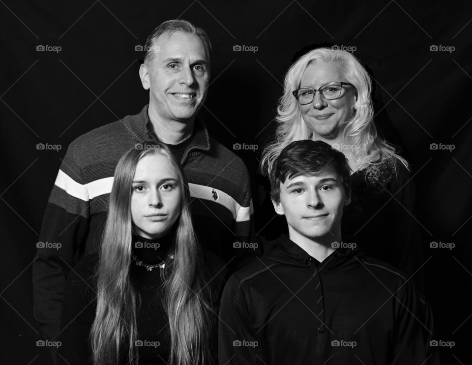 Professional family portrait. Black-and-white, family of four. Made with Nikon mirrorless Z6, 24mm S lens at f/4.5, 50mm