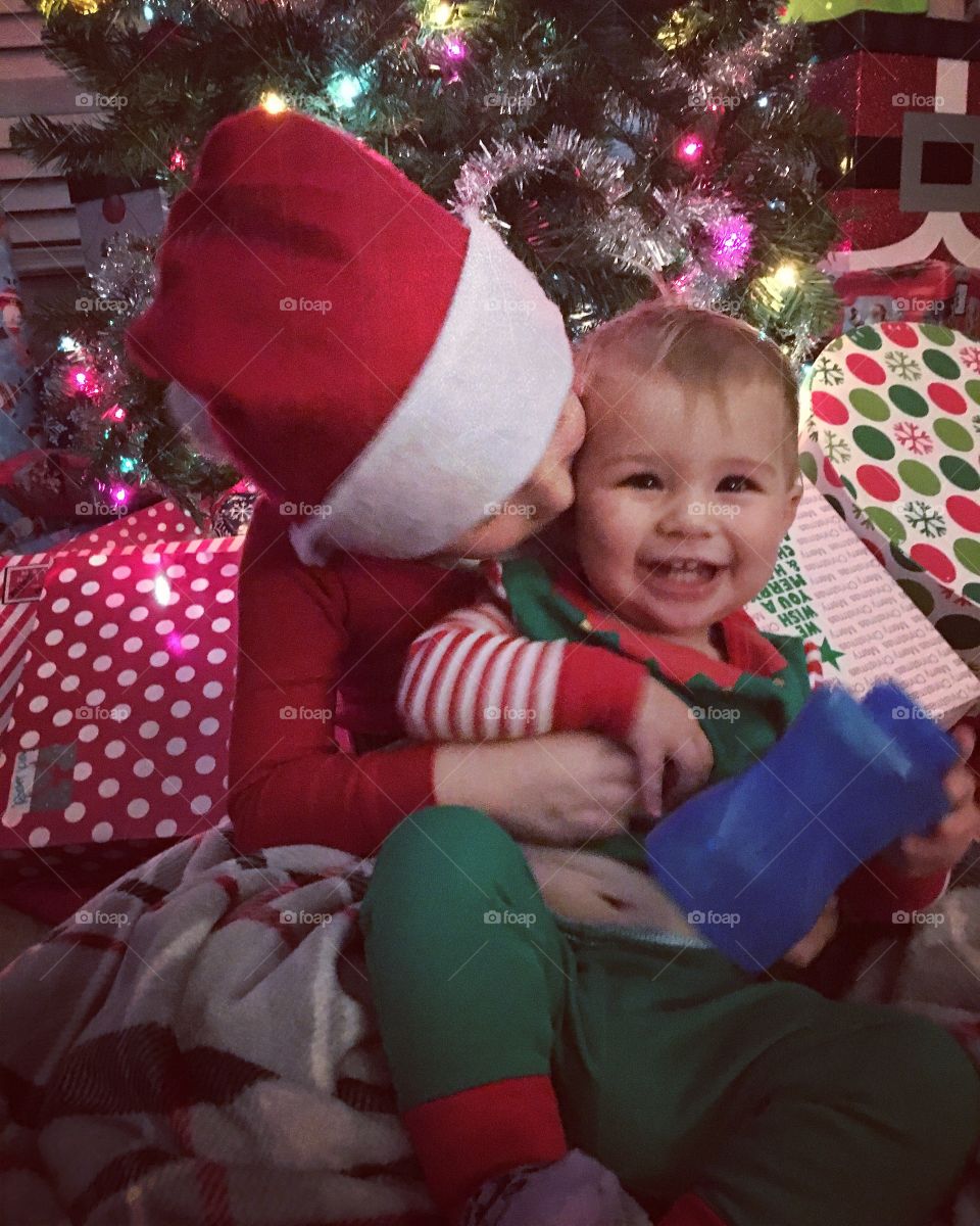 Close-up of a brother and sister near christmas tree