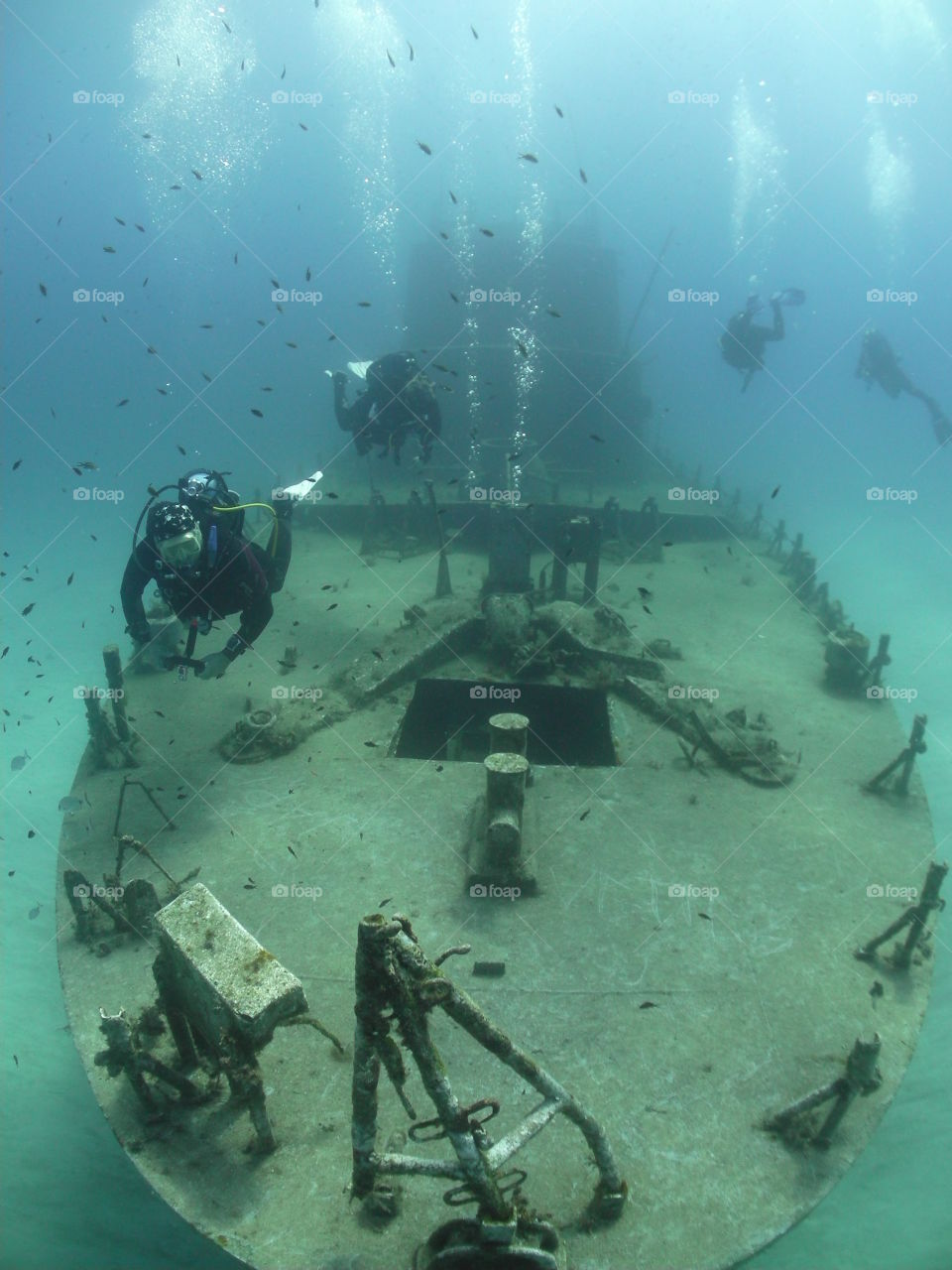 scuba divers on a shipwreck