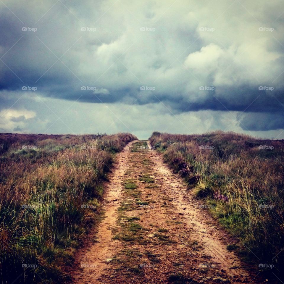 Dark clouds over the dirt road