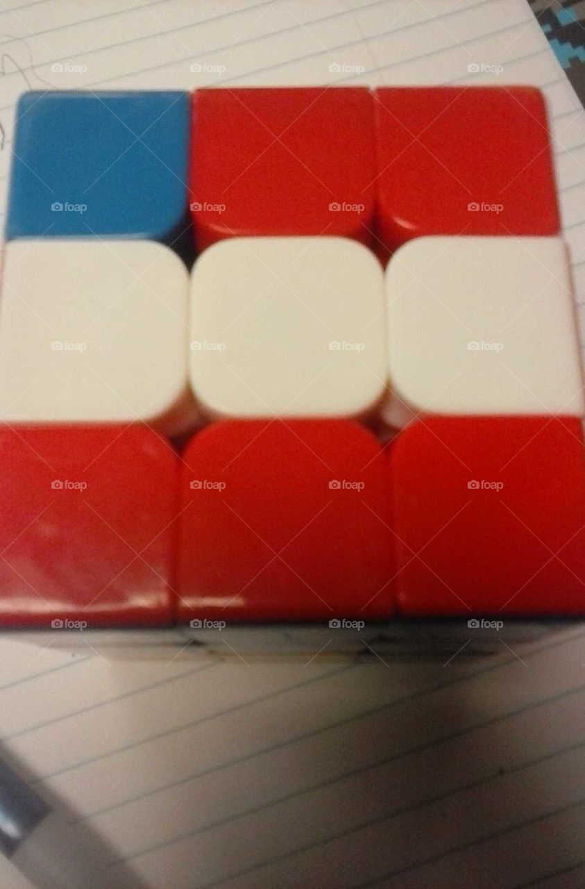 patriotic American flag rubics cube. On a notebook paper background.