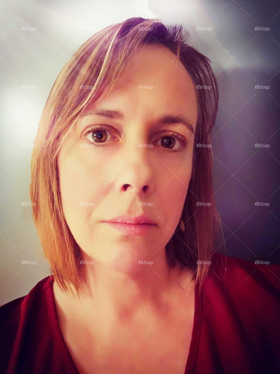 woman with a red blouse smiling