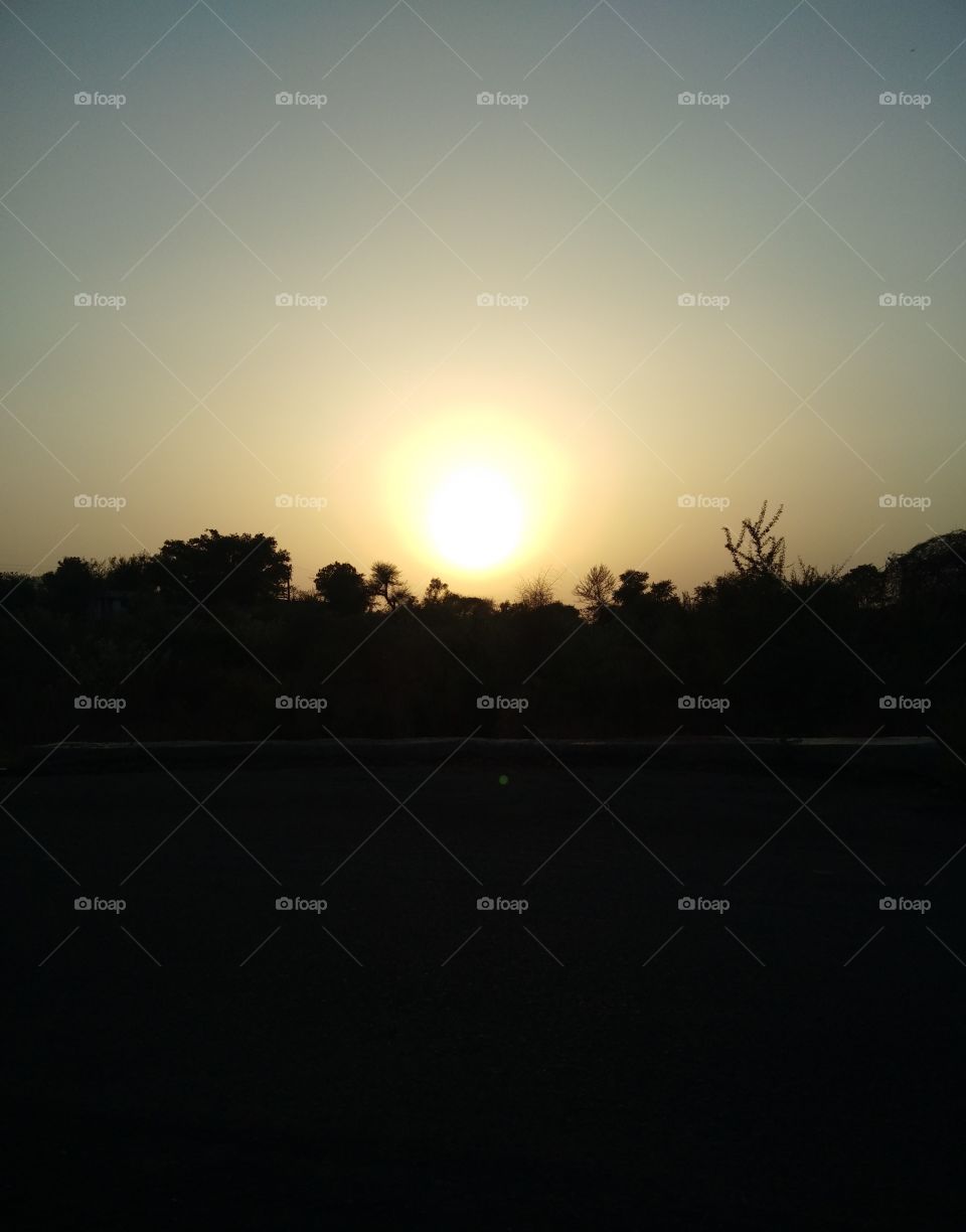 An orange haze casted over the moving sea, reflecting off every wave. Half of a glowing,radiant light loomed on the water's horizon. A warm sensation was splashed onto my face from the beaming raysof the sun.A calmness flew by with the wind making...