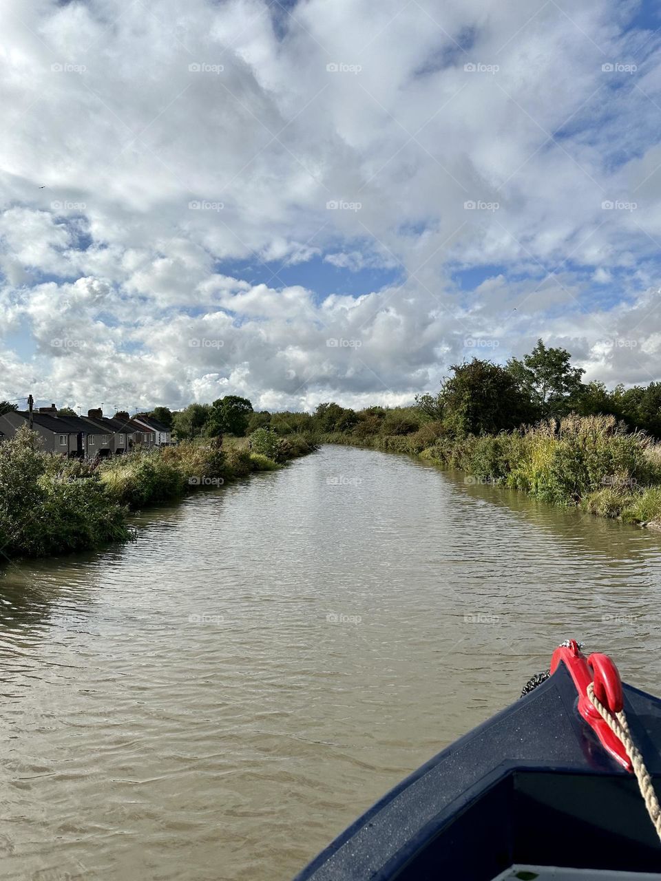 Great late summer weather cool sunny sky clouds narrowboat cruise Oxford canal near Ansty village historic waterway vacation England countryside peaceful holiday relaxing