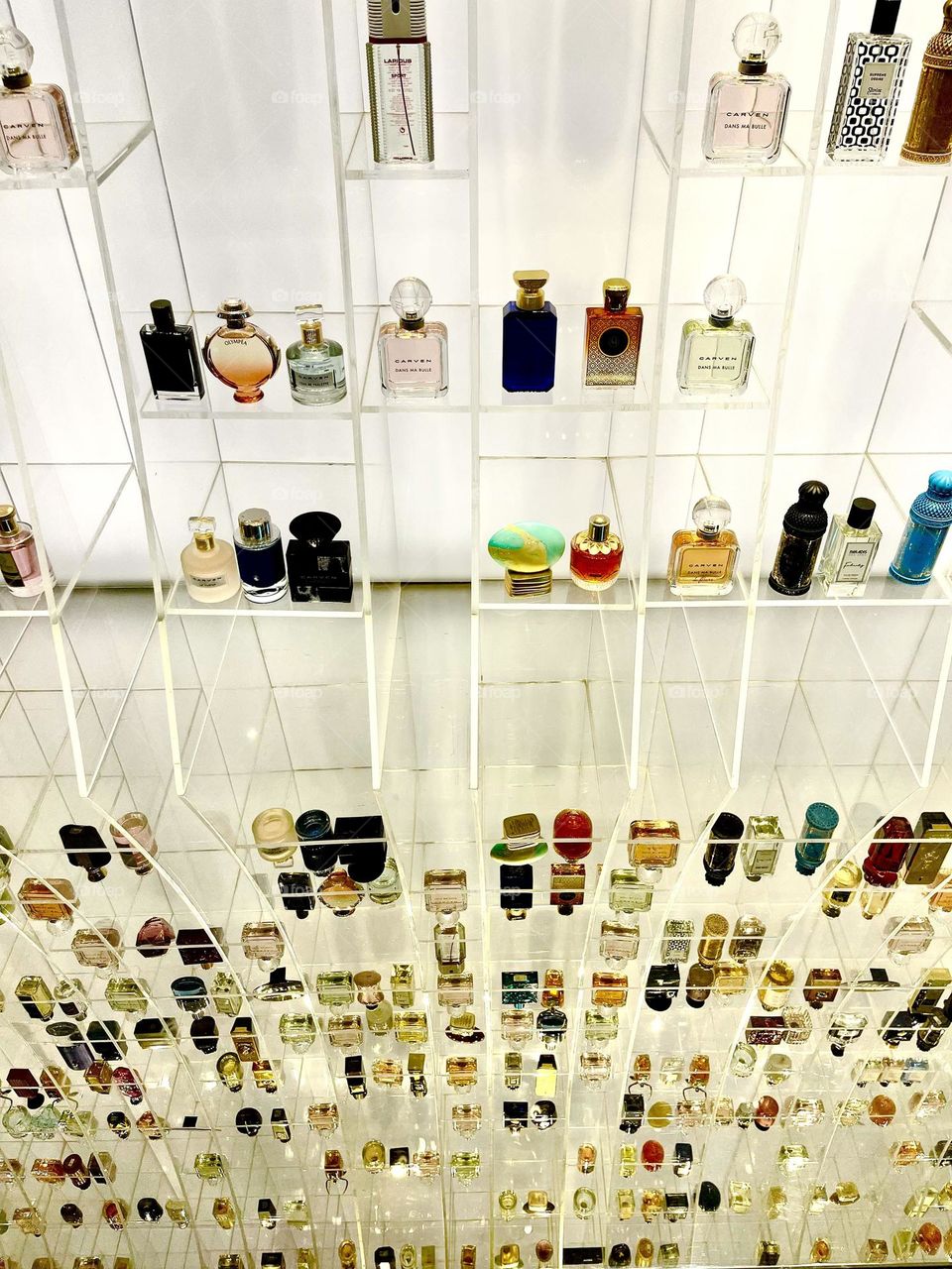 Perfumes display with reflection