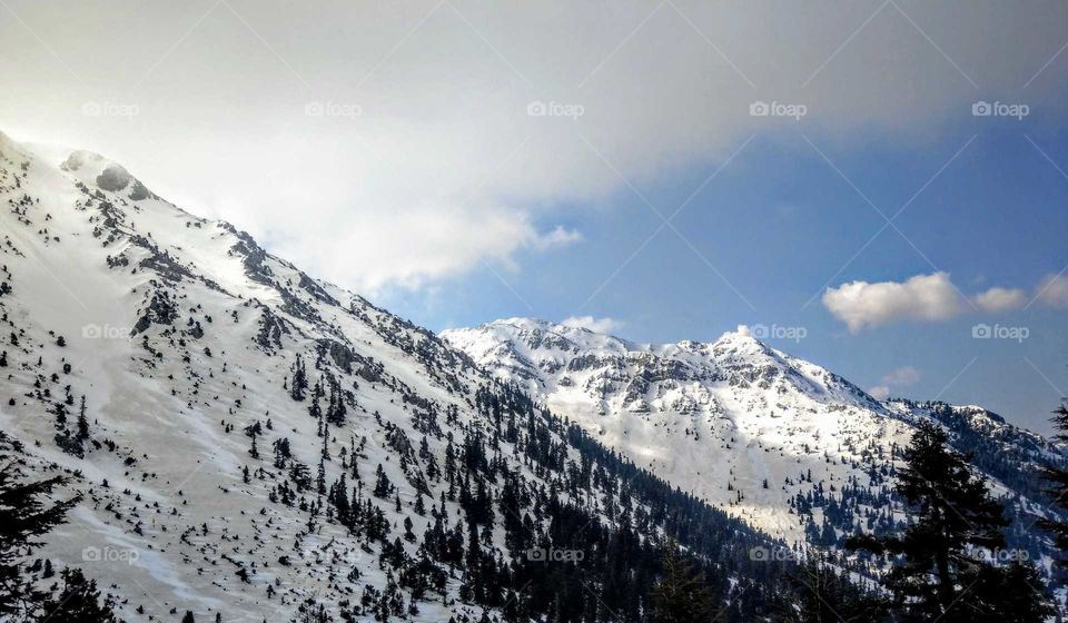 beautiful snow mountains and sun shines on the mountain.