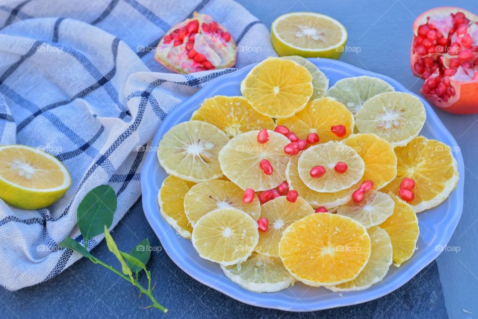 slices of orange and lime on a plate