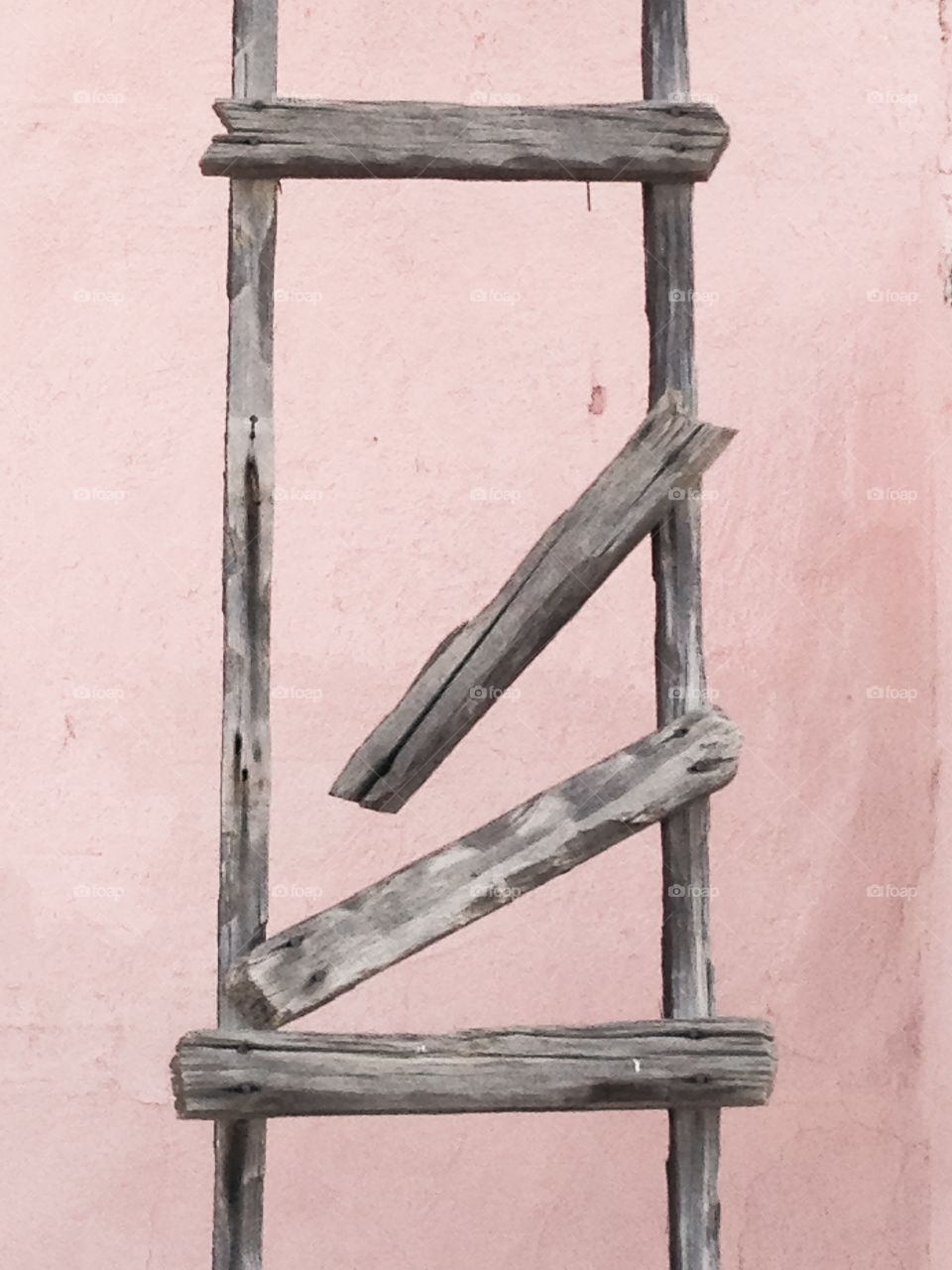 Broken ladder against wall