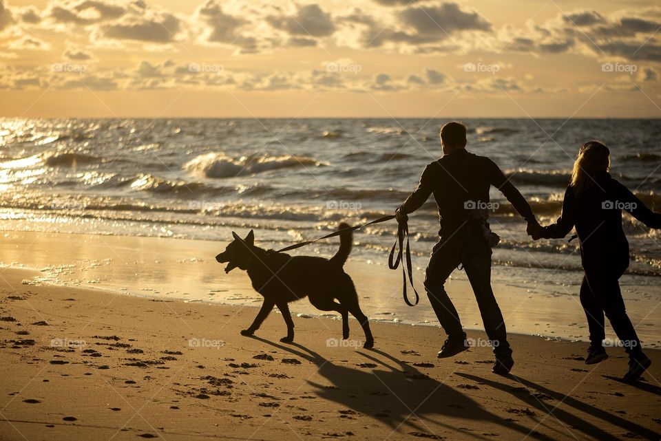 Family with dog on the beach