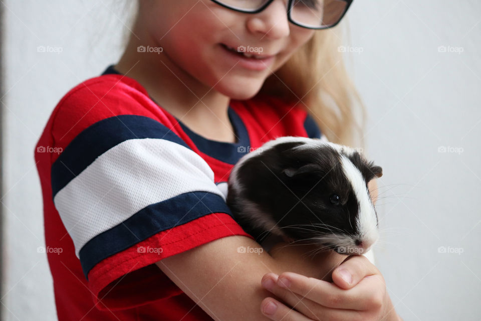 Girl playing with her guinea pig
