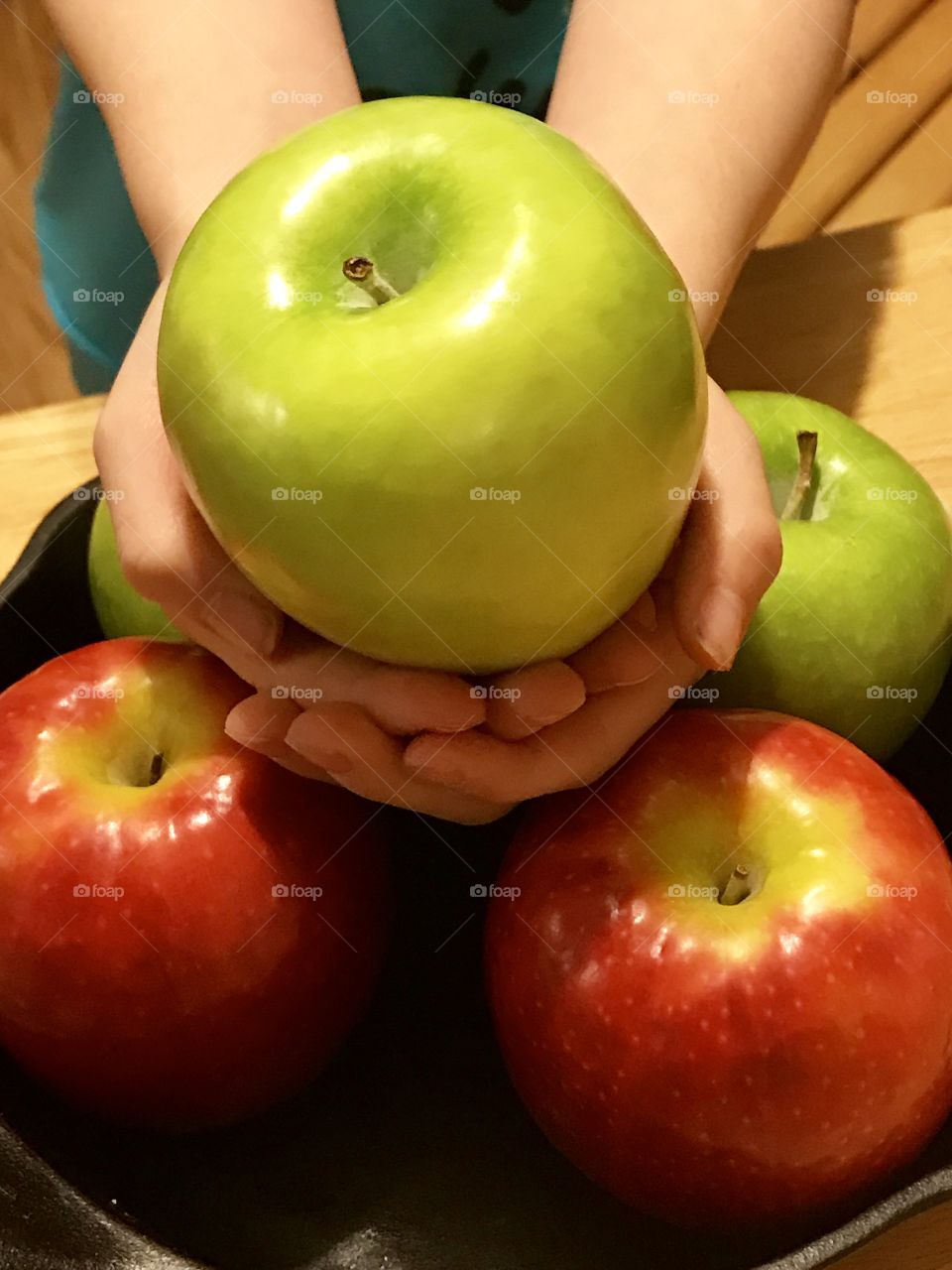 Human hand holding apple