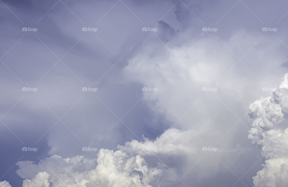 The beauty of the sky with clouds and the sun in summer.