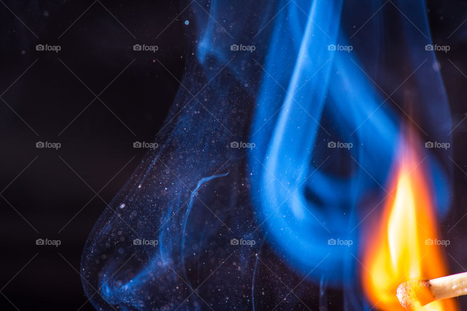 Match with smoke and fire on black background  copyspace