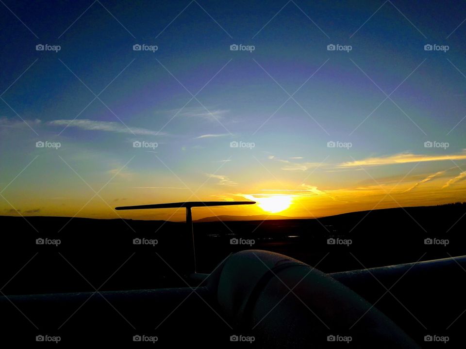 Sunrise over a DG-505 Elan glider at the Long Mynd