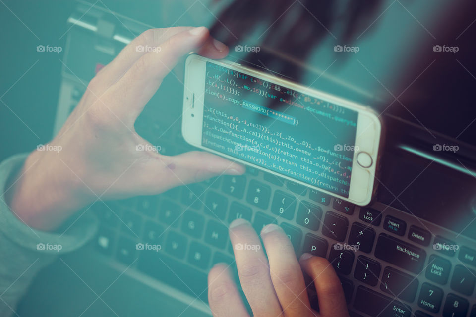 Hacker using computer, smartphone and coding to steal password and private data. Screen displaying program code, website development, application building, password and private data
