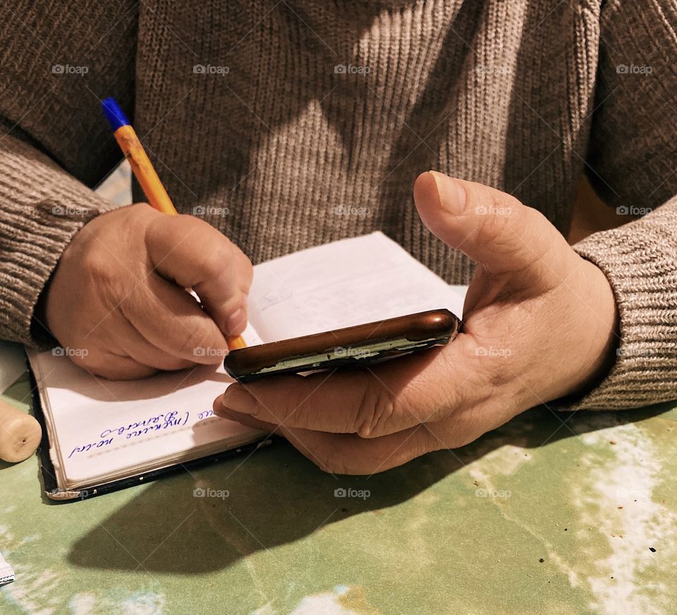 People writing on notebook