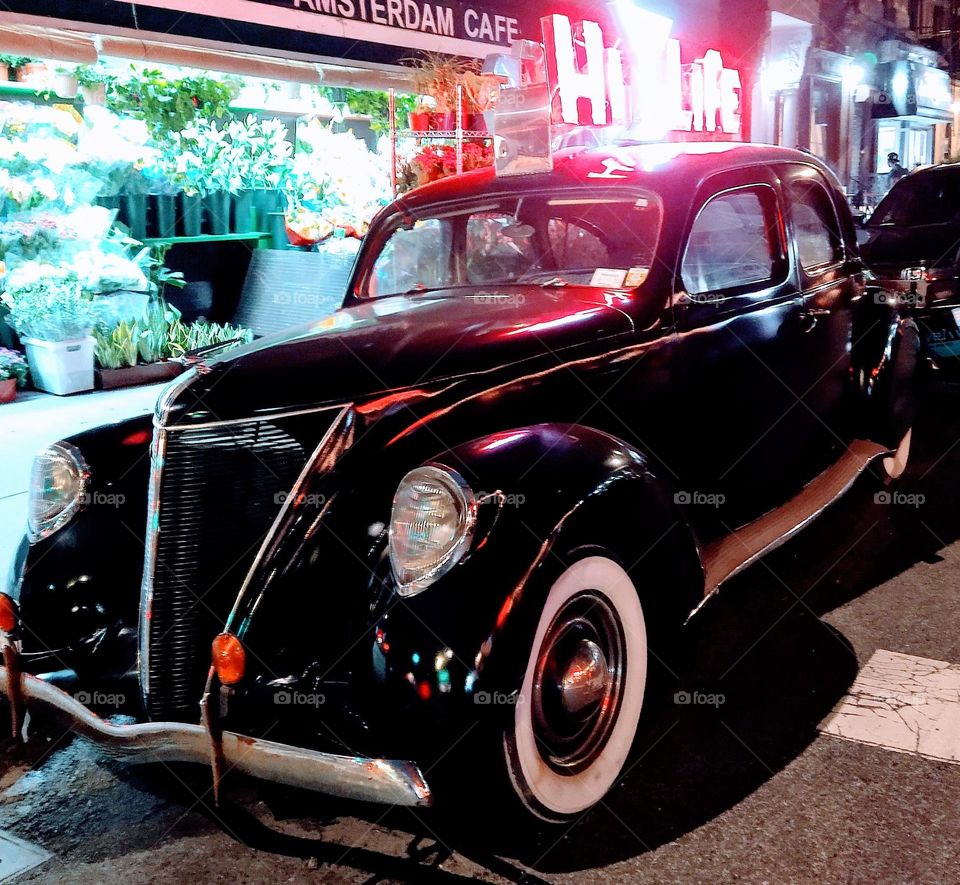 Vintage Car Sits Outside of the Hi-Life Bar and Restaurant it Advertises