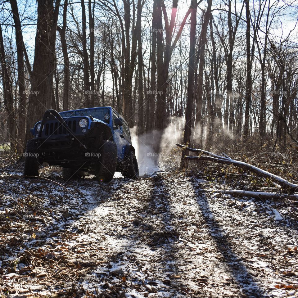blue jeep slinging mud