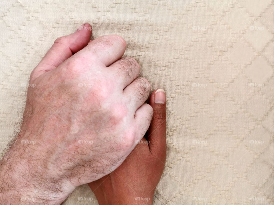 Man's hand holding woman's hand with love. Unconditional love concept between Caucasian man and Thai woman. No racism concept image.