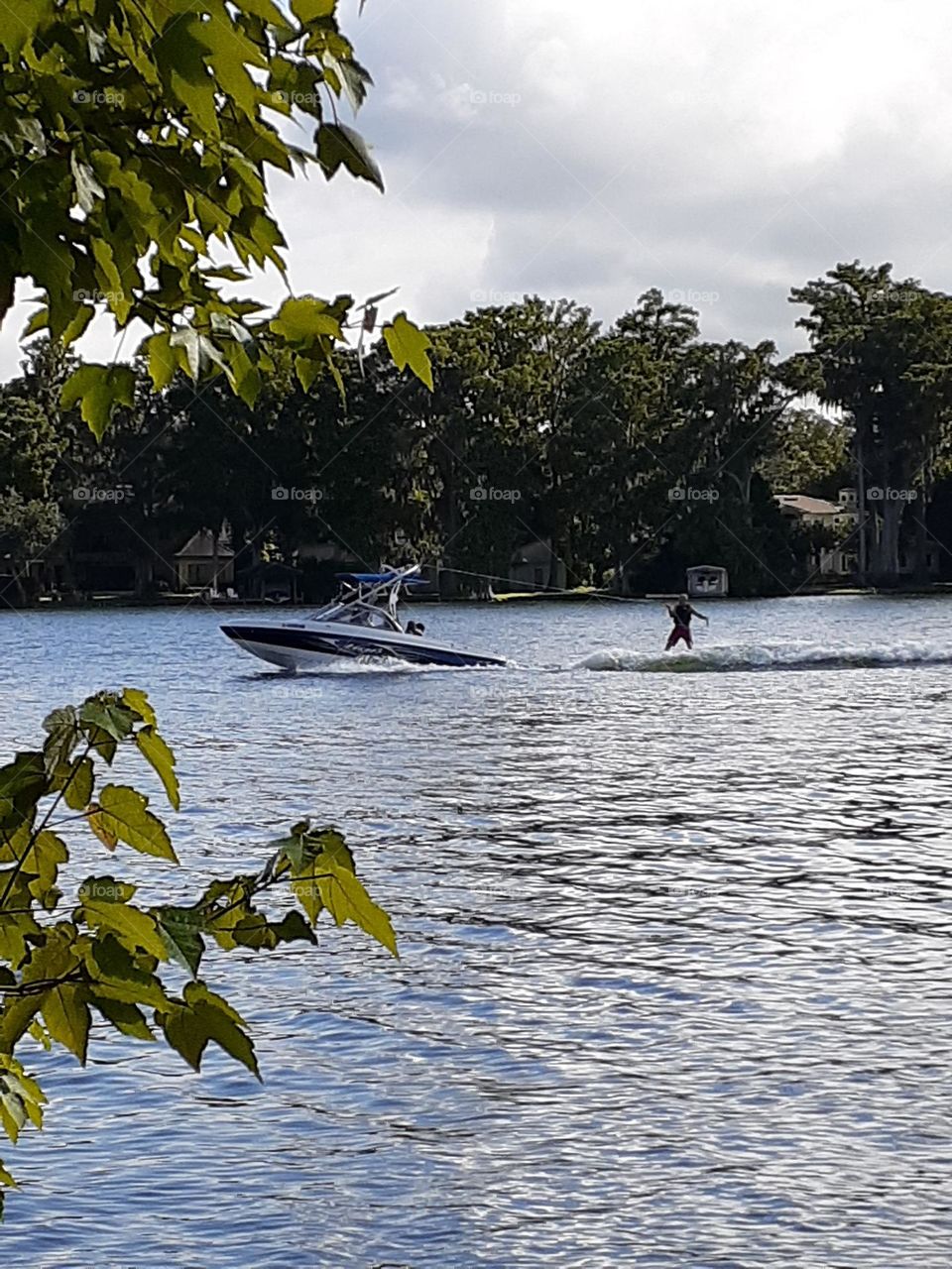 A man water skies in the lake while being pulled behind a boat at Kraft Azalea Park.