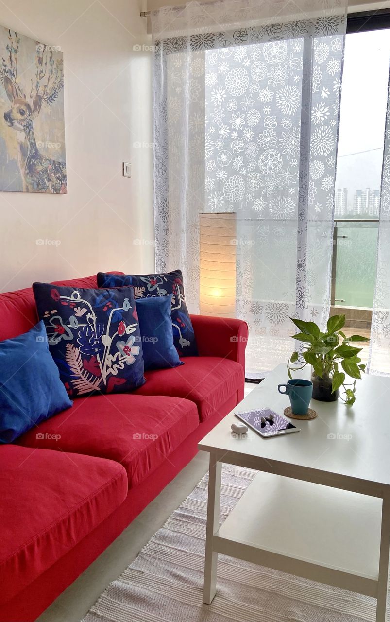 My favorite relaxing spot at home on my red sofa! 