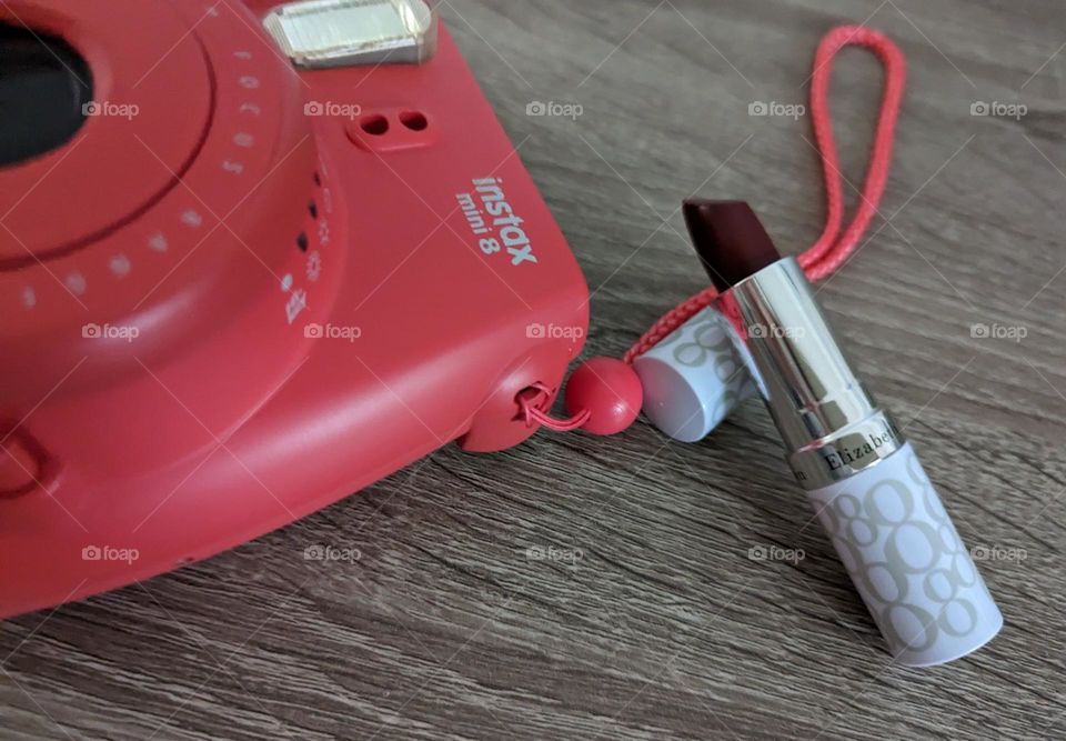 Magenta instant camera and magenta lipstick