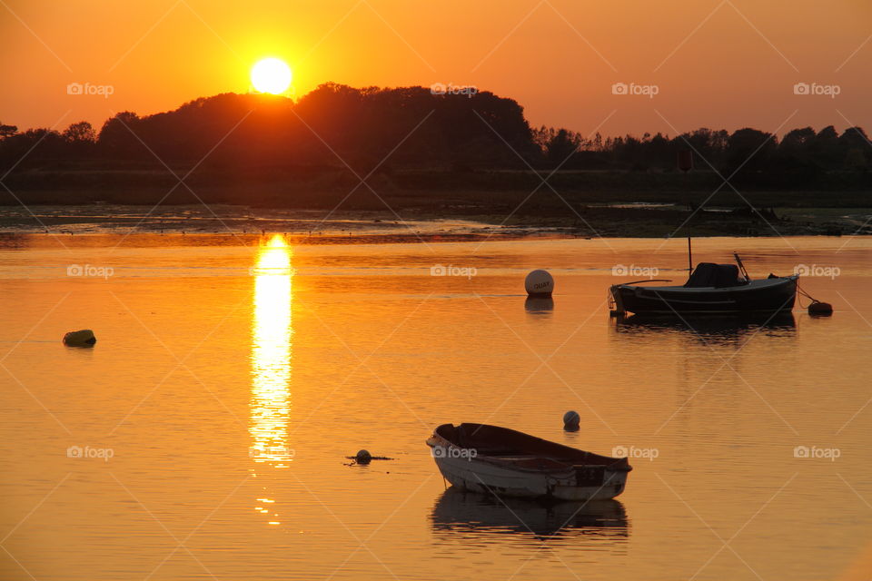 Boat in sea during sunset