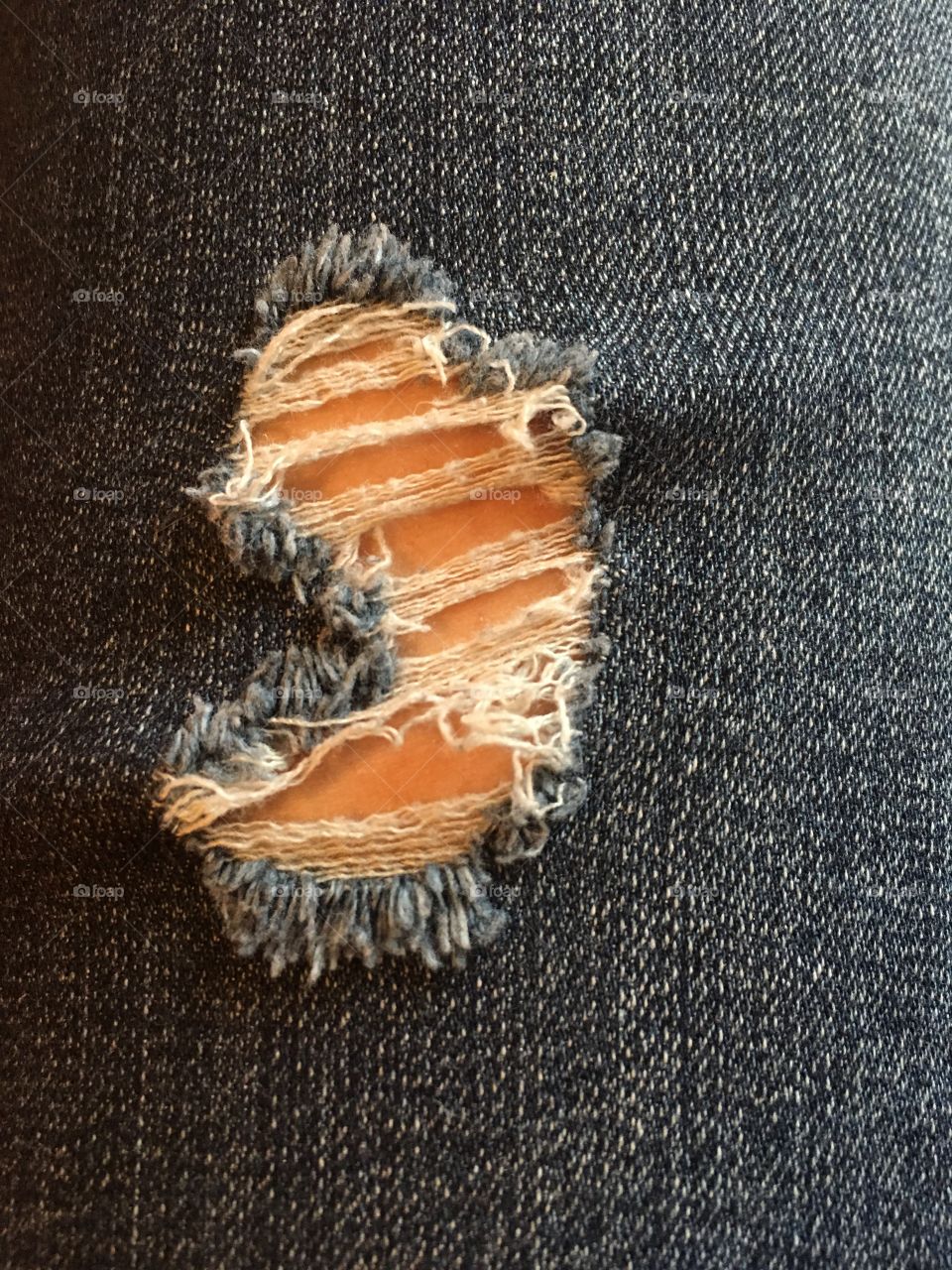 Stylish tear in jean fabric 