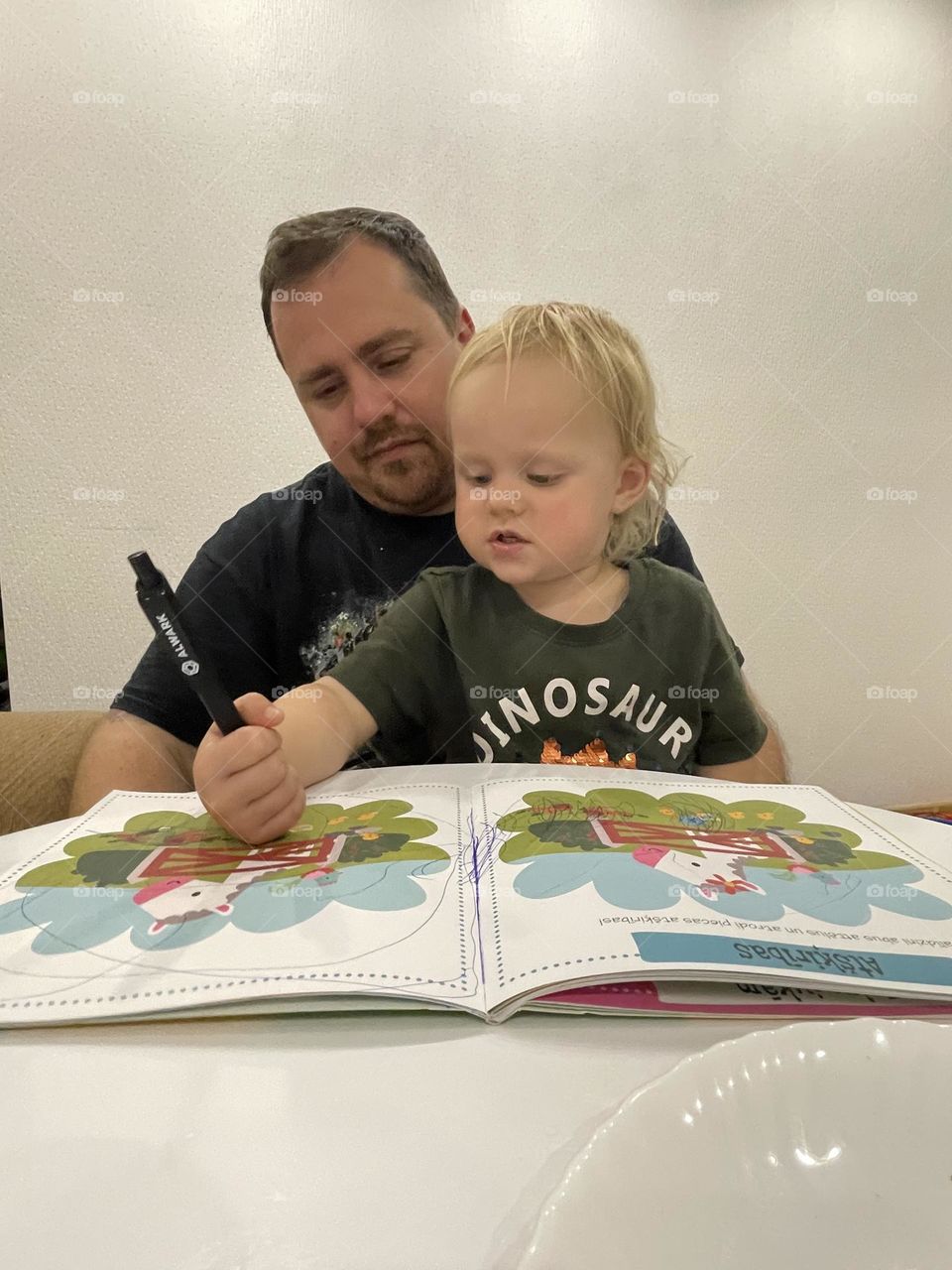 Dad and daughter doing some educational work at home