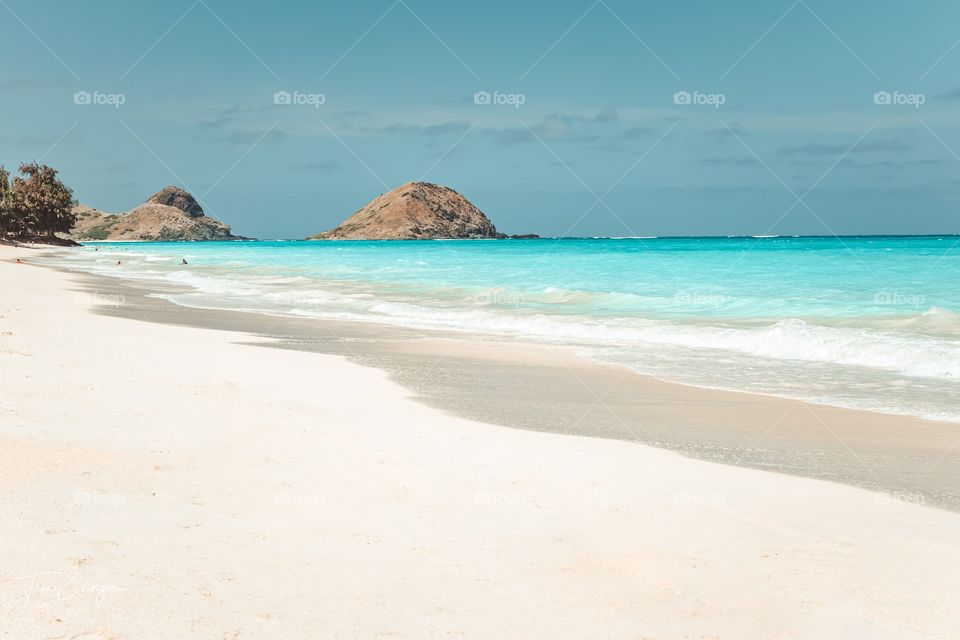 White sandy beach of Hawaii with a view of the mok islands.  