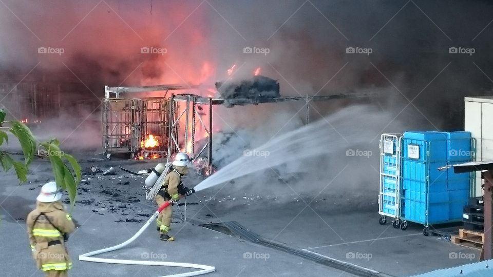 Fire fighters trying to extinguish fire