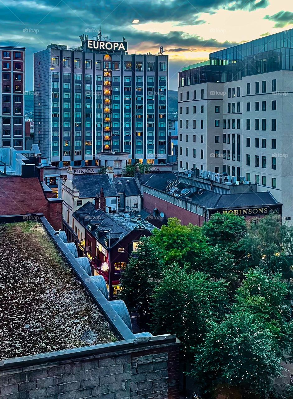 Belfast, Northern Ireland begins to light up as dusk approaches.