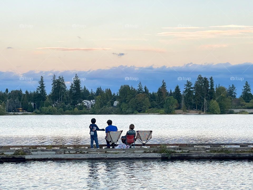 Family fishing at the lake in the evening 