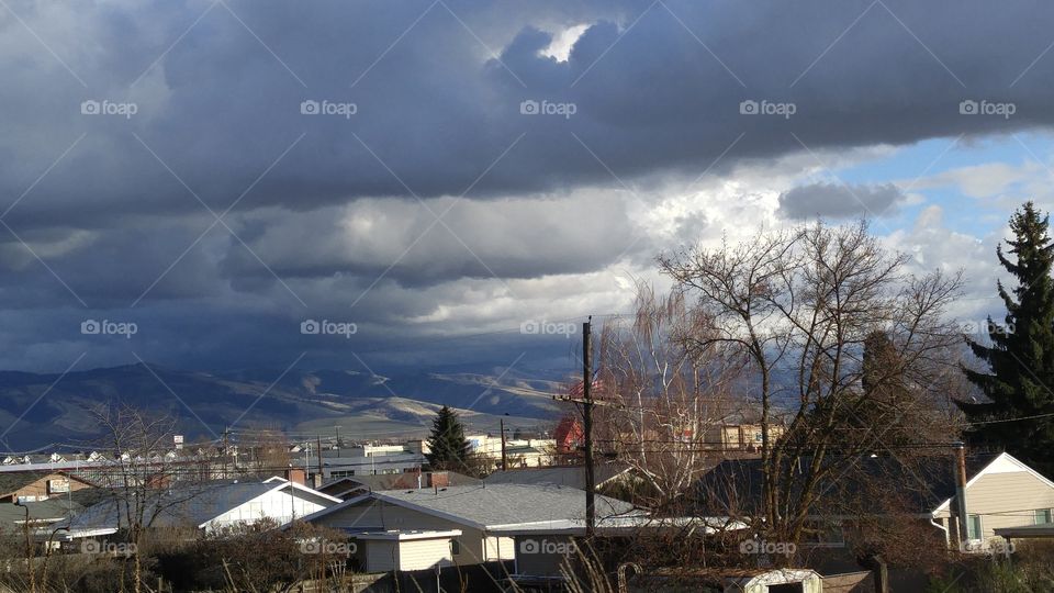 clouds over city and hills
