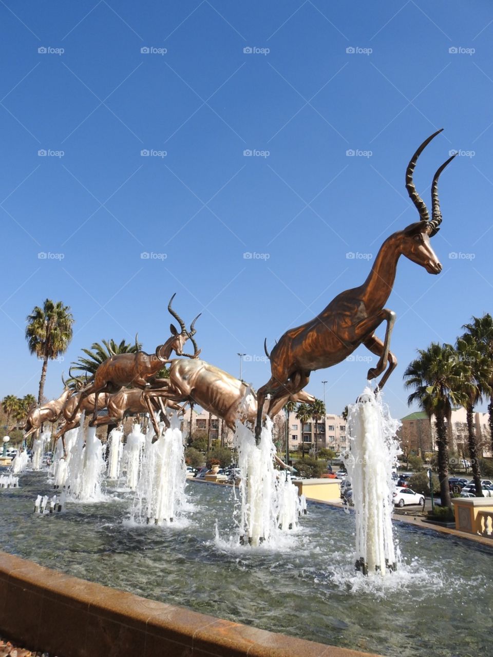The most beautiful sculpture of golden impala running through the fountains in front of the Gold Reef City Casino, Johannesburg