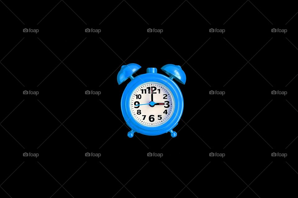 Blue clock on black background 