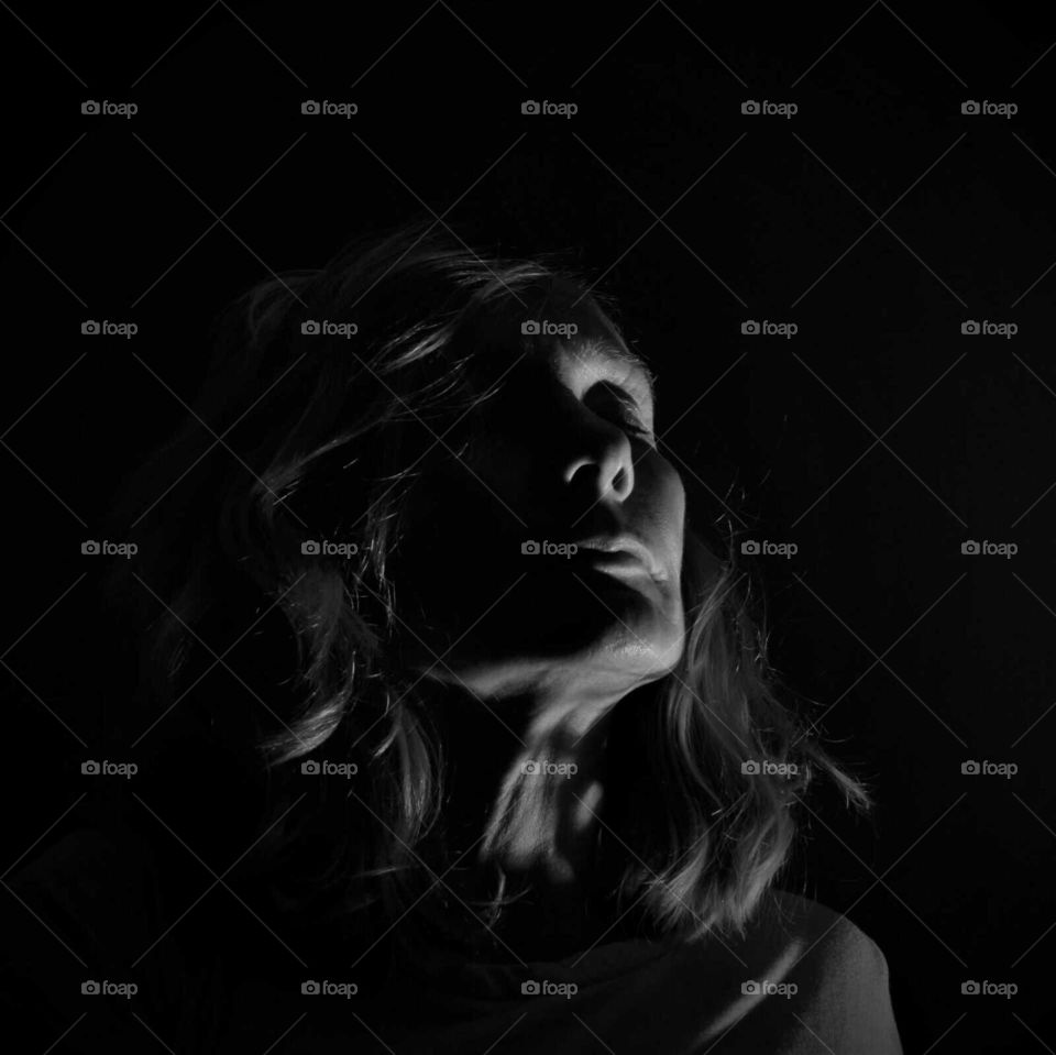 mysterious woman low key black and white close up portrait