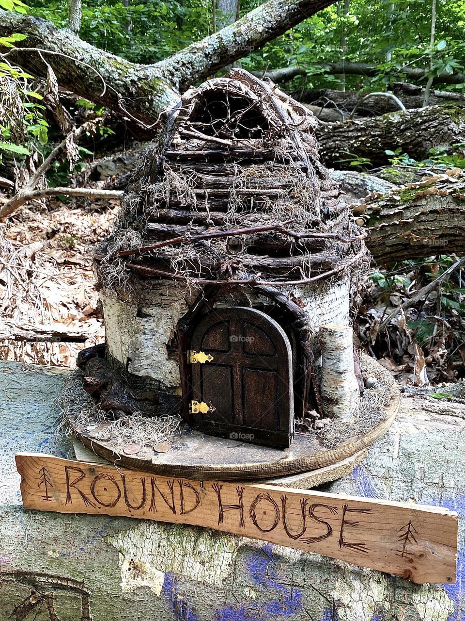 Fairy wooden miniature house with metal hinges on door.