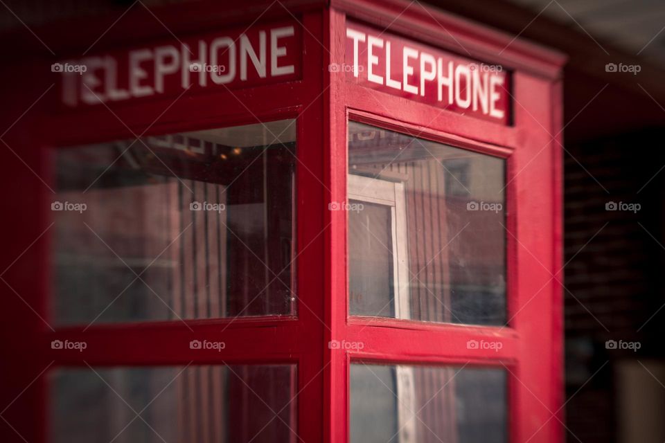 Vintage Retro Red Telephone Booth with Windows outdoors