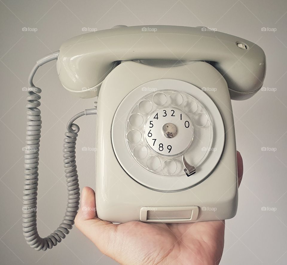Hand holding old school telephone 2
